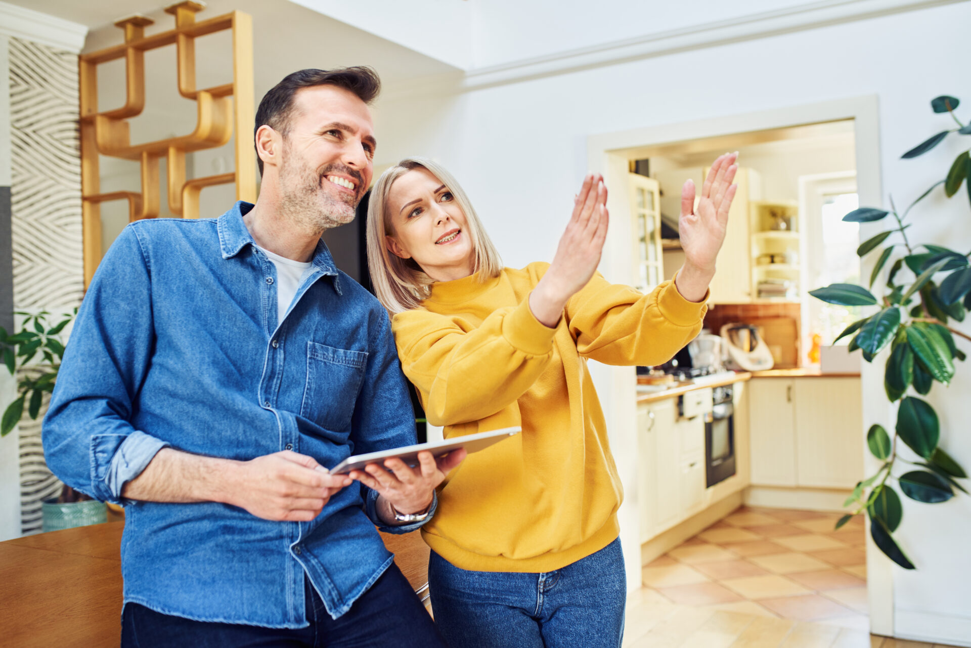 Middle aged couple at home planning living room design